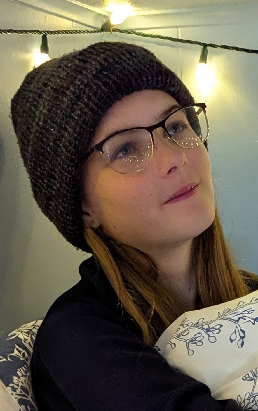 Jael wearing one of her hand-knit merino wool beanies